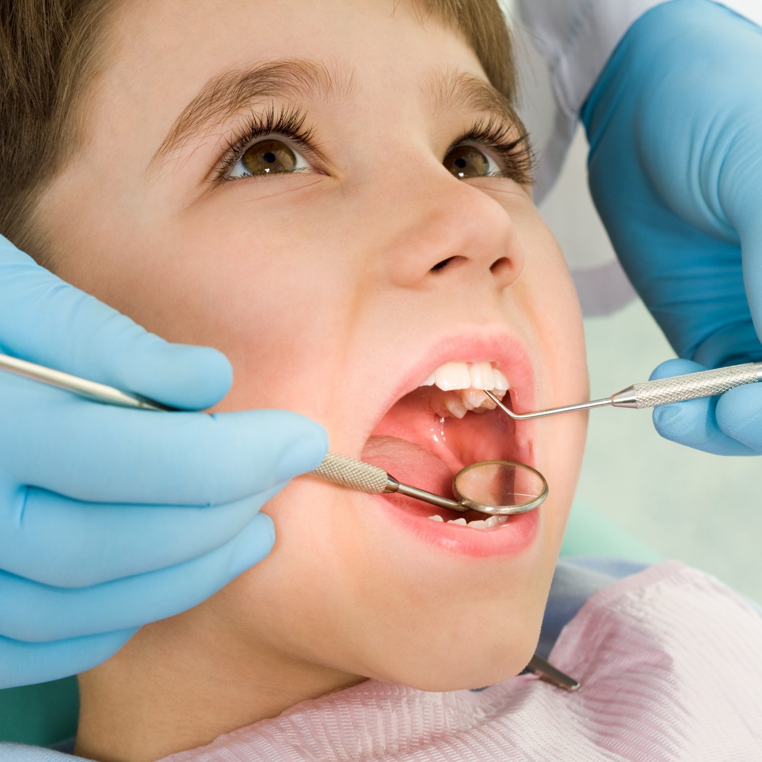 AdobeStock_281626595 v2 Girl showing of her clean teeth at the dentist for a preventive dental appointment in Franklin WI
